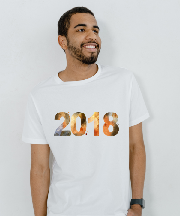 Smiling man wearing a stylish white t-shirt with colorful "2018" graphic print
